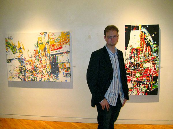 Kyle Clements standing infront of his paintings at Moore Gallery. September, 2011